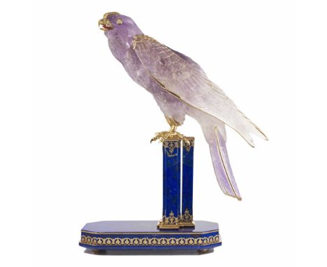 A RARE GOLD & DIAMOND SET OBJET D'ART MODEL OF A FALCON PERCHED ON A GOLD & LAPIS LAZULI BASECIRCA 1980sCarved amethyst Falco