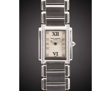 A LADIES STAINLESS STEEL & DIAMOND PATEK PHILIPPE TWENTY-4 BRACELET WATCHDATED 2006, REF. 4910/10A-011 WITH SILVER DIAMOND DI