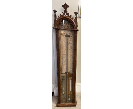 An oak cased barometer by the late Admiral Fitzroy. 118cm x  24.5cm. Marked to interior wooden thermometer  J Penton &amp; co