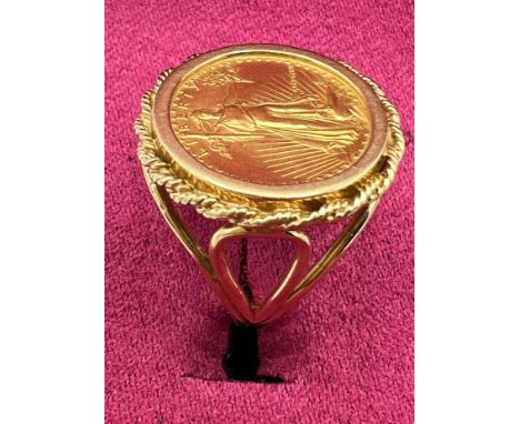 A 1986 Liberty Gold 5 Dollar coin ring set in 14 carat gold. Size O. Weight 7.8gm. 