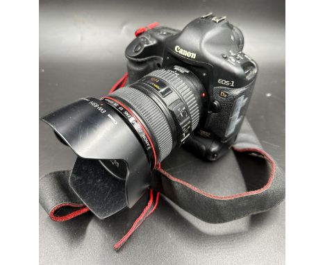 A Canon EOS1 Ds Mark II digital camera with a Canon 24-105mm 1/4 L IS USM Lens and Canon charger pack and instruction manual.