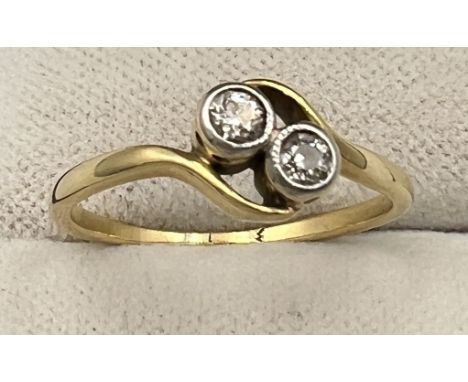 An unmarked yellow metal ring set with two diamonds. Size K. Weight 1.9gm. 