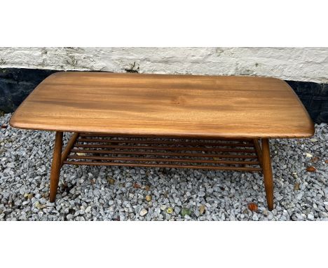 Ercol coffee table with magazine rack to base. 105cm l x 46cm w x 35cm h. 