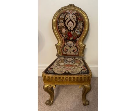 A 19thC giltwood child’s chair with original woolwork tapestry back and seat on cabriole legs. 84cm h to back. 