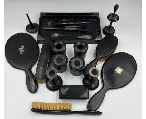 A quantity of ebony and silver mounted dressing table items to include tray, candlesticks, hand mirrors, ring stand, hair tid