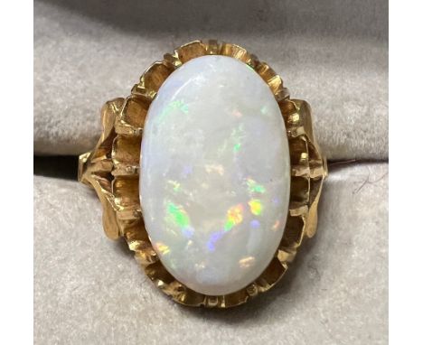 An oval opal in claw setting in yellow metal, tests as 22 carat gold. Size J, weight 5.5gm.Opal 15mm x 10mm.