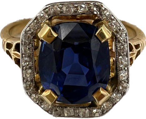 A sapphire and diamond ring mounted in 18 carat gold and platinum. Size N/O. Weight 4.3gm. The cushion shape oval sapphire ap