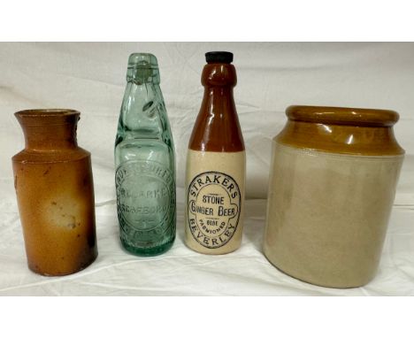 A stoneware bottle labelled 'Straker's Stone Ginger Beer, Beverley', along with a Codd bottle R. Clarke, Scarboro and two oth