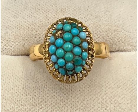 A yellow metal ring with turquoise stones. Size N/O. Weight 4.1gm. 