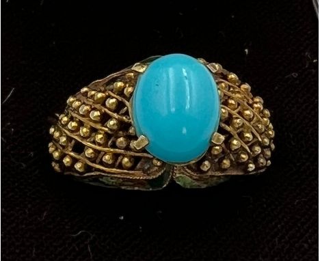 A 14 carat gold ring set with turquoise stone with enamel decoration to the sides. Size N, weight 6.1gm. 