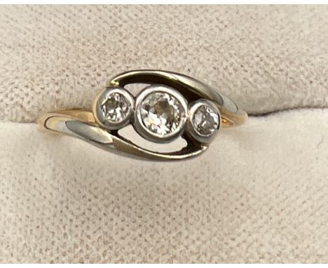 An unmarked yellow and white metal ring set with three diamonds. Size J/K. Weight 2.4gm. 