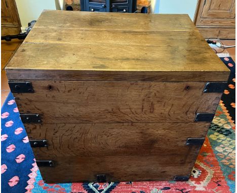 A metal bound oak trunk with metal drop handles to each side and two lift out interior trays. 78cm w x 59cm d x 70cm h. 