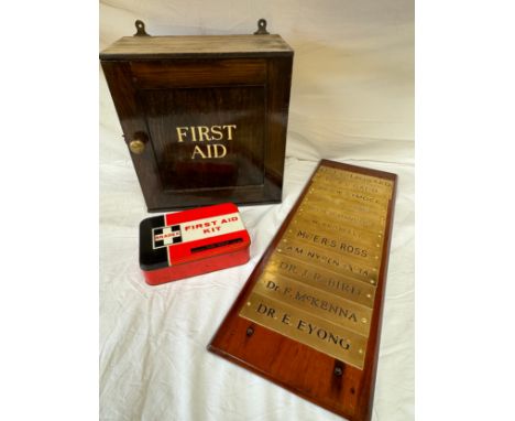 A wooden plinth, 70cm h x 24cm w, displaying a list of 11 Doctors/Consultants on brass name plates along with a wooden vintag