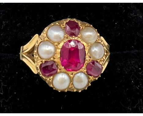 An 18 carat gold ring set with rubies and split pearls. Size M/N. Weight 
