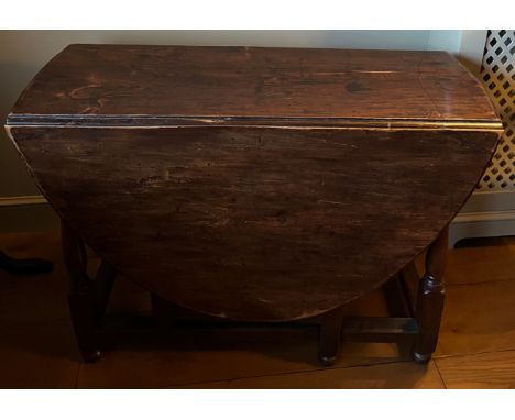 A George I elm gate-leg table with drawer to one end. 102cm x 137cm open. 41cm closed. 