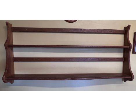 An oak wall hanging shelf unit. 127 w x 63cm h. 