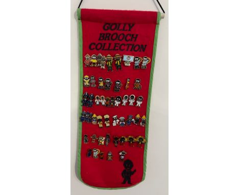 Fifty various Robertsons ‘Golly’ badges on ‘Golly Brooch collection red felt wall hanging, to include one made by Gomm.These 