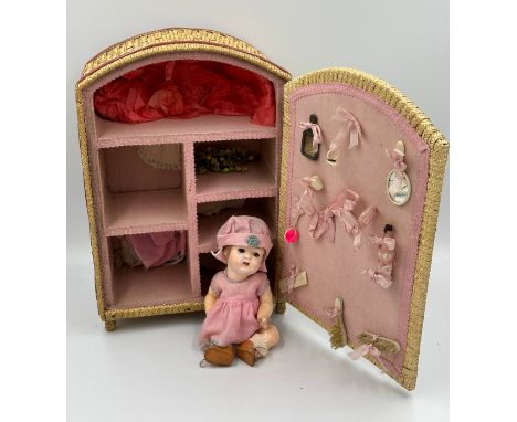 A collection of three early 20thC bisque headed dolls of various sizes together with a doll's vintage wicker wardrobe with dr