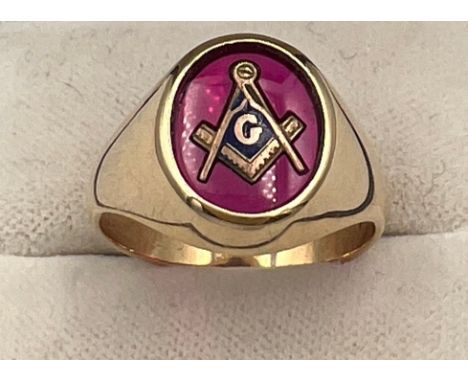A 14 carat gold Masonic ring with synthetic ruby and Masonic symbol. Size R/S. Weight 7.2gm. 