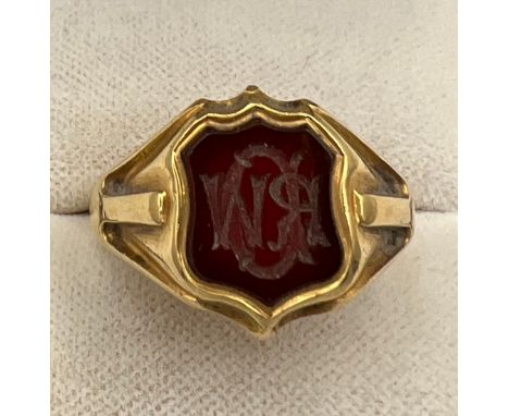 An 18 carat gold signet ring with onyx initialled seal to the front. Weight 11.8gm. Inscribed inside From A.M.Eadon to R.W.De