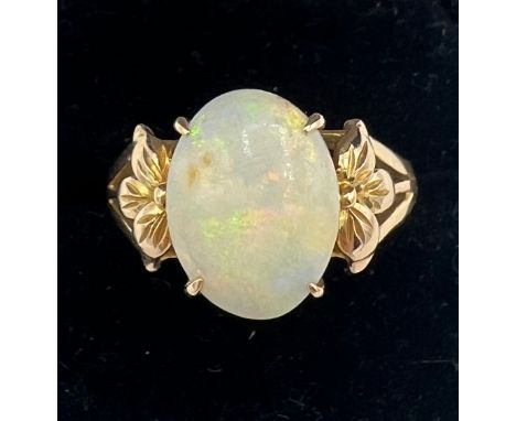 An opal ring mounted in 14 carat yellow gold. Size R. Weight 4gm. 