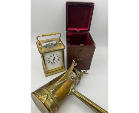 A brass cased carriage clock with French movement in original leather covered carrying case with key together with an Eastern