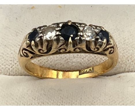 An 18 carat gold ring set with sapphires and diamonds. Size O. Weight 5.5gm. 