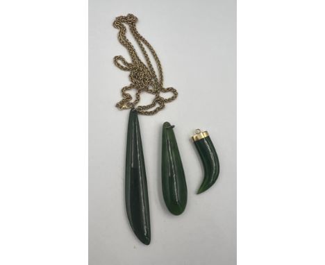 Three jade pendants, one with a 9 carat gold chain, length 60cm, weight approximately 12gm, one with an unmarked yellow metal