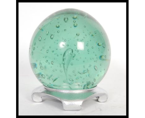 A large 19th Century Victorian Nailsea green glass paperweight dumb of bulbous form having large central bubble being convert