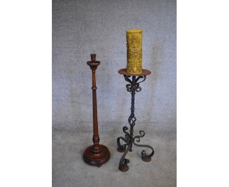 A wrought iron floor standing pricket candlestick and a turned wooden example. H.100cm 
