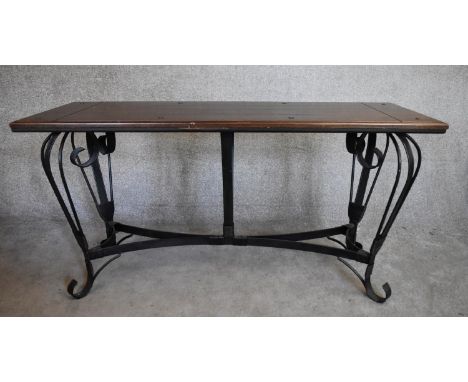 A rectangular console table with planked cleated hardwood top on metal cabriole scrolling supports. H.77x155x55cm 