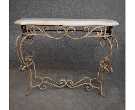 A mid 20th century white painted wrought iron console table with shaped marble top on scrolling cabriole supports. H.87x112cm