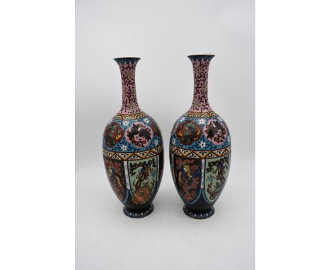 A pair of late 19th century Chinese cloisonné enamel vases with floral decoration and a phoenix chasing and pearl and dragon 