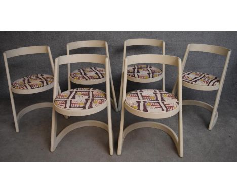 A set of 1970's vintage dining chairs of modernist design with original abstract design seat coverings. H.75x50cm 