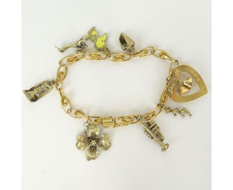 Vintage 14 Karat Yellow Gold Charm Bracelet with One (1) 14 Karat Heart Charm and Seven (7) Sterling Silver Charms. Signed. G