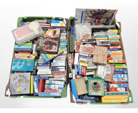 Two boxes containing a large quantity of playing card sets and games.