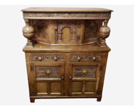 An early 20th century heavily carved oak buffet sideboard, 122 cm wide x 49 cm deep x 145 cm high 