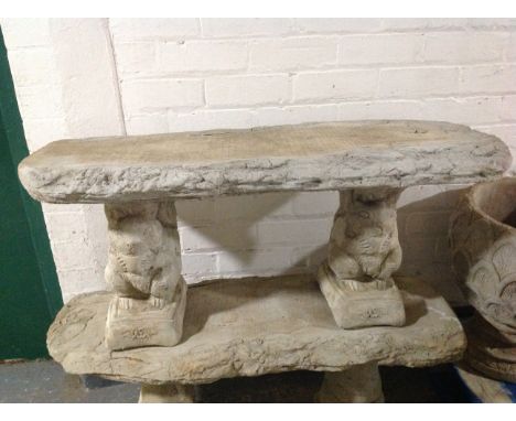 A concrete rustic garden bench on squirrel pedestals, width 100cm.