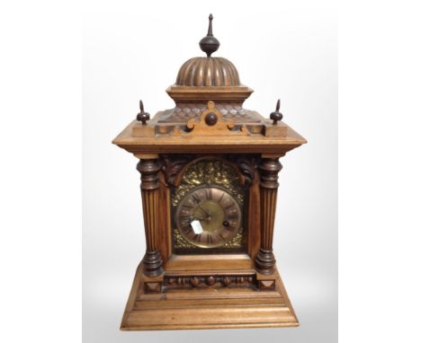 A Victorian walnut bracket clock, with brass dial striking on a gong, labelled verso 'H A C 14-day strike made in Wurttemberg