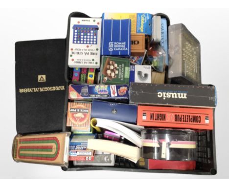 A group of quiz books, trivia games, other games including Solitaire, Cribbage, and Backgammon board, etc.