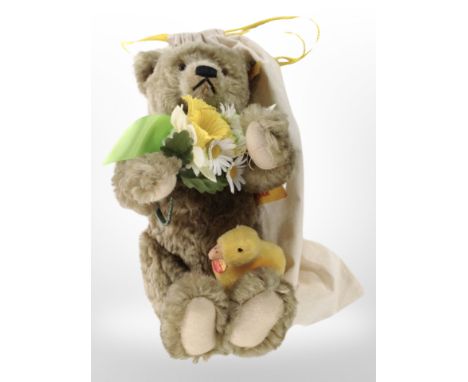A Steiff mohair teddy bear with tags and protective cloth bag.