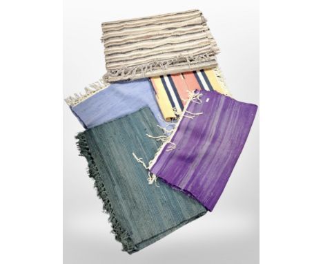 A group of vintage rugs and mats.