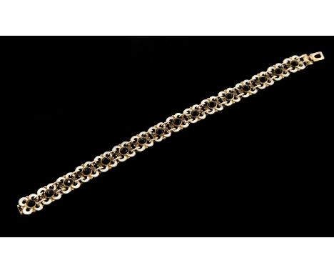Willy Winnaess for David Andersen - a Norwegian silver and enamel bracelet, sixteen floral links with black enamel cabachon c