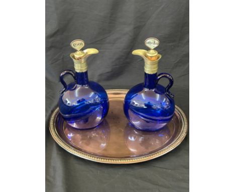 Two vintage blue glass decanters on a silver plate tray 
