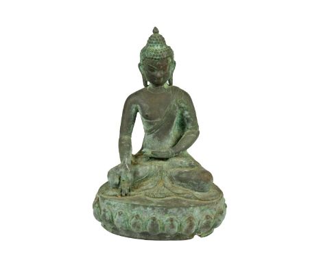 This is a patinated bronze buddha who is seated with the legs crossed, the left hand in the lap, and the right hand pointing 