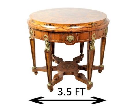 Beautiful 42" round inlaid table, classical Egyptian revival style. This exquisite center table features bronze mounts and fi