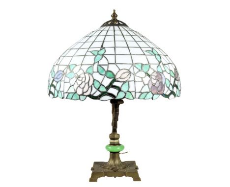 This is an American art deco table lamp with a leaded glass dome shade. There is a rose and vine design along the rim of the 