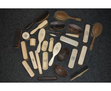 A collection of early 20th century dressing table brushes, a shoe horn, two trinket dishes, a cylindrical pot, letter opener,