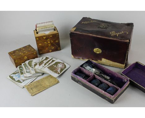 A card games box for Rubicon, Bezique and Piquet, an inlaid playing cards box, Victorian playing cards and an ink rolling set