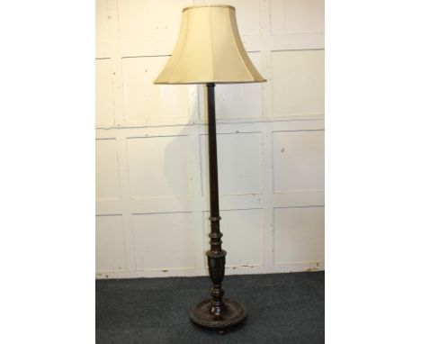 A mahogany standard lamp with reeded baluster stem on circular base